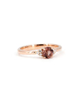 Close-up of the Désir Cushion Peach Spinel Ring, showcasing its delicate rose gold setting, vibrant spinel center stone, and sparkling diamond accents. Designed by Bena Jewelry.