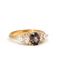 Handcrafted peacock sapphire ring by Bena Jewelry, made in Montreal, featuring asymmetrical white diamonds and color-changing center stone on a clean white backdrop.