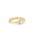 Side view of the Heart & Pear Trinity Ring, showcasing its refined gold band and elegant diamond setting.