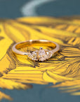 Close-up of the pear-shaped diamond engagement ring, featuring heart-cut side diamonds.