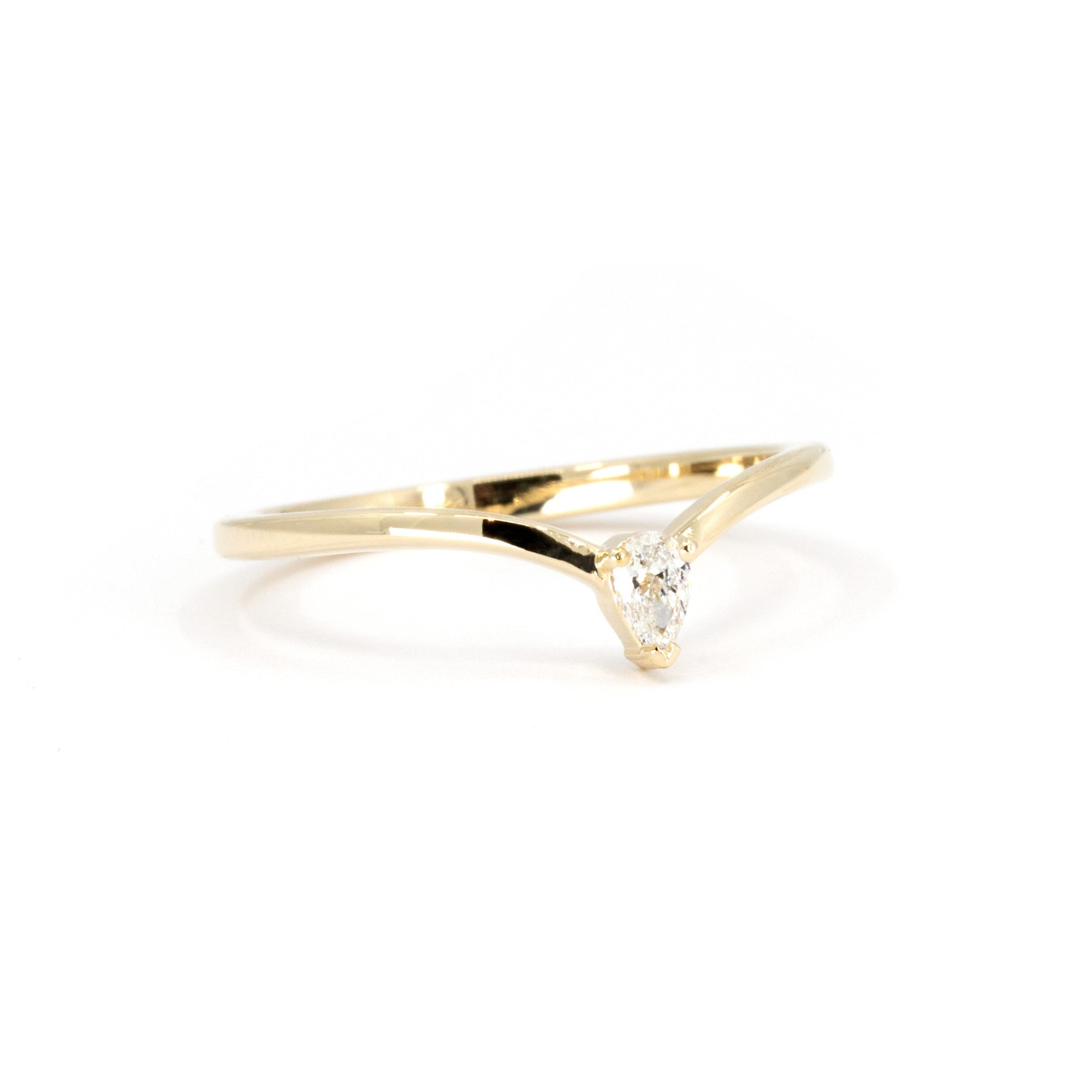 Side view of the minimalist ring with a small pear-shaped lab-grown diamond, highlighting the sleek curve of the band. Handcrafted by Bena Jewelry in Montreal for a timeless and ethical design.