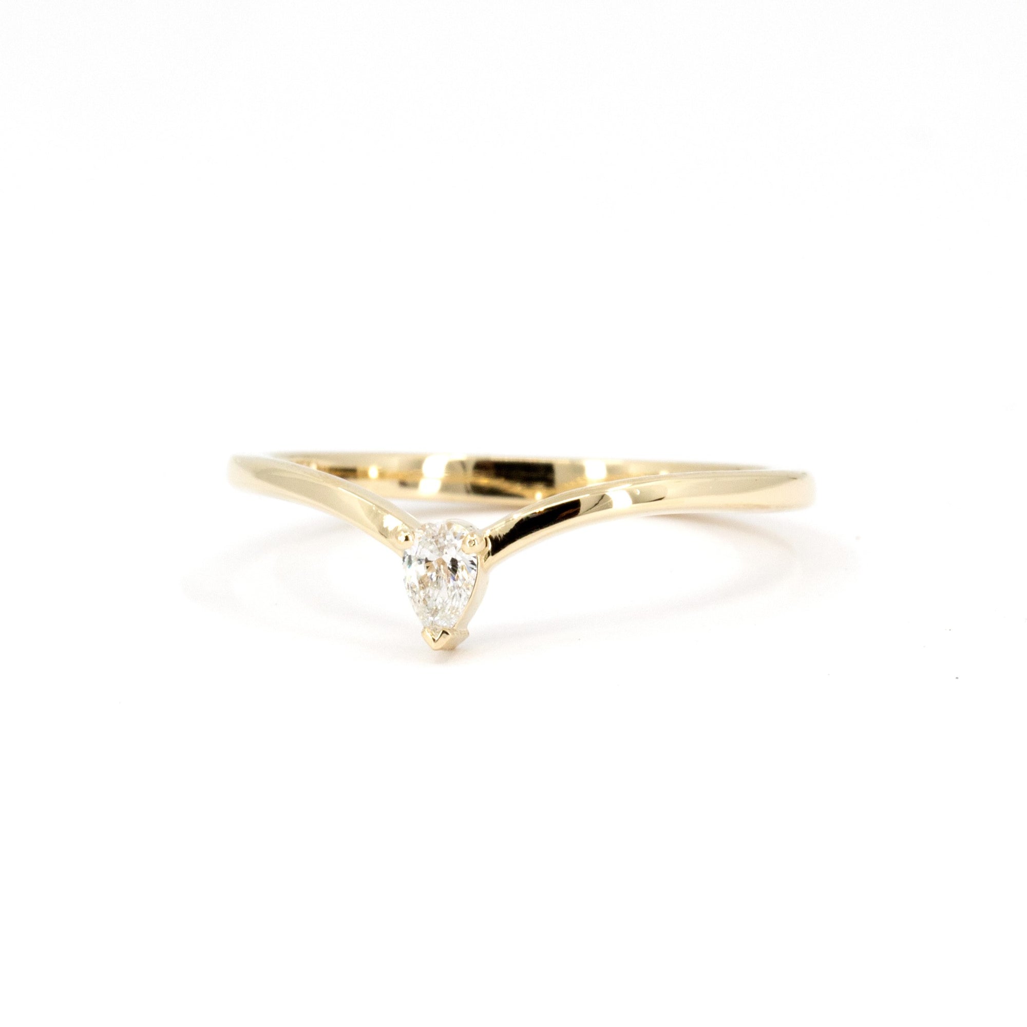 "Minimalist ring with a pear-shaped lab-grown diamond, featuring a delicate curve on the band. Handcrafted by Bena Jewelry, an independent artisan in Montreal, this piece embodies simple elegance.
