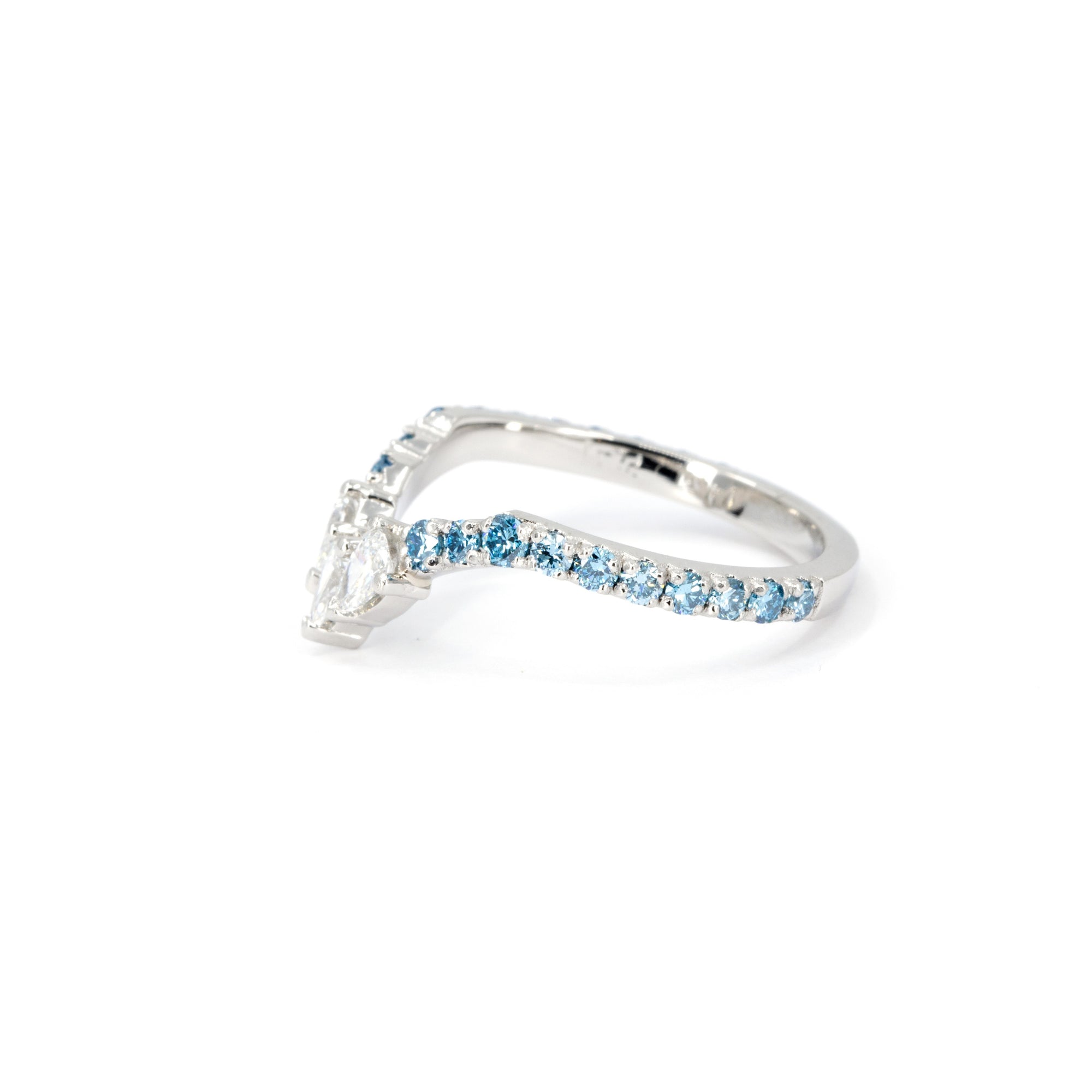 Side view of the Blue Mirage ring in platinum, showing the gentle V shape and gradient of blue and white diamonds.