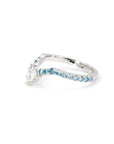 Side view of the Blue Mirage ring in platinum, showing the gentle V shape and gradient of blue and white diamonds.