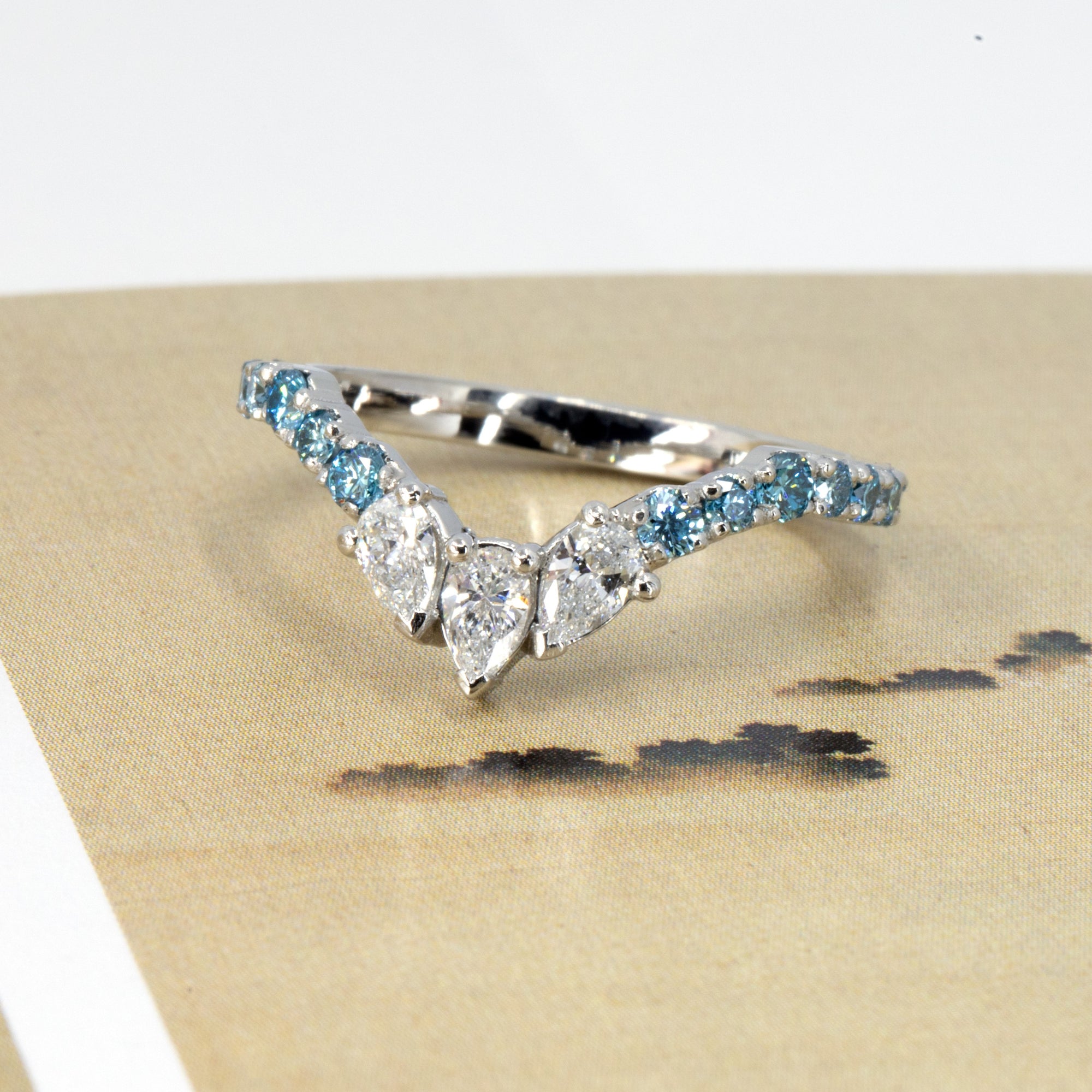 Top-down view of the Blue Mirage platinum ring, highlighting the symmetry and sparkle of the diamond setting by Bena Jewelry.