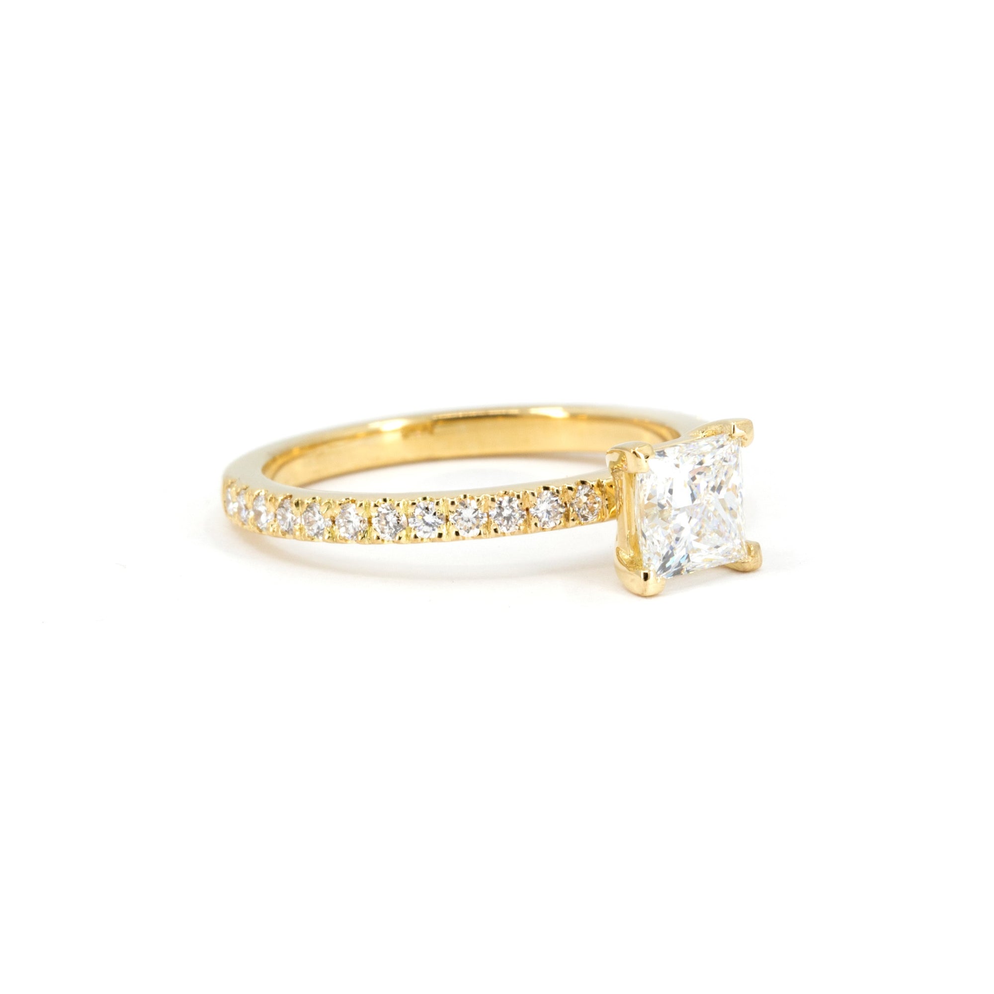 Handcrafted princess-cut diamond ring in 18k yellow gold by Bena Jewelry, minimalist and modern design, shown on a plain white background.