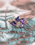 Close-up: Focuses on the vibrant hues of the sapphires and the sparkle of the diamonds against the yellow gold. Made by Bena Jewelry, Montreal, Canada.