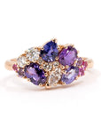 Front view: The Avalanche Purple Pink Sapphire Ring showcasing its artistic arrangement of purple and pink sapphires with diamonds in a polished yellow gold setting. Designed by Bena Jewelry in Montreal, Canada.