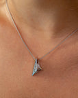 Close-up of the Bena Jewelry Pyramid Pendant in white gold, featuring a powerful angular design and a mix of sparkling white and champagne diamonds, embodying strength, edge, and modern elegance.