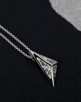 Bold geometric pendant in white gold, featuring golden-brown and white diamonds, glowing against a dark backdrop. Handmade in Montreal by Bena Jewelry.