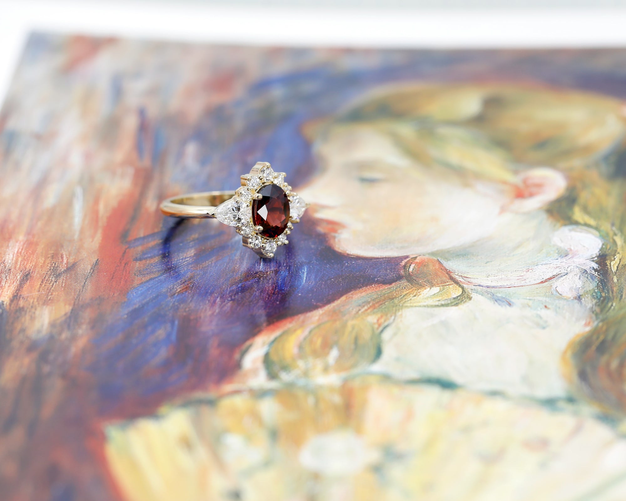 side view of bena jewelry oval shape pyrope garnet diamond ring custom made in montreal by bena jewelry