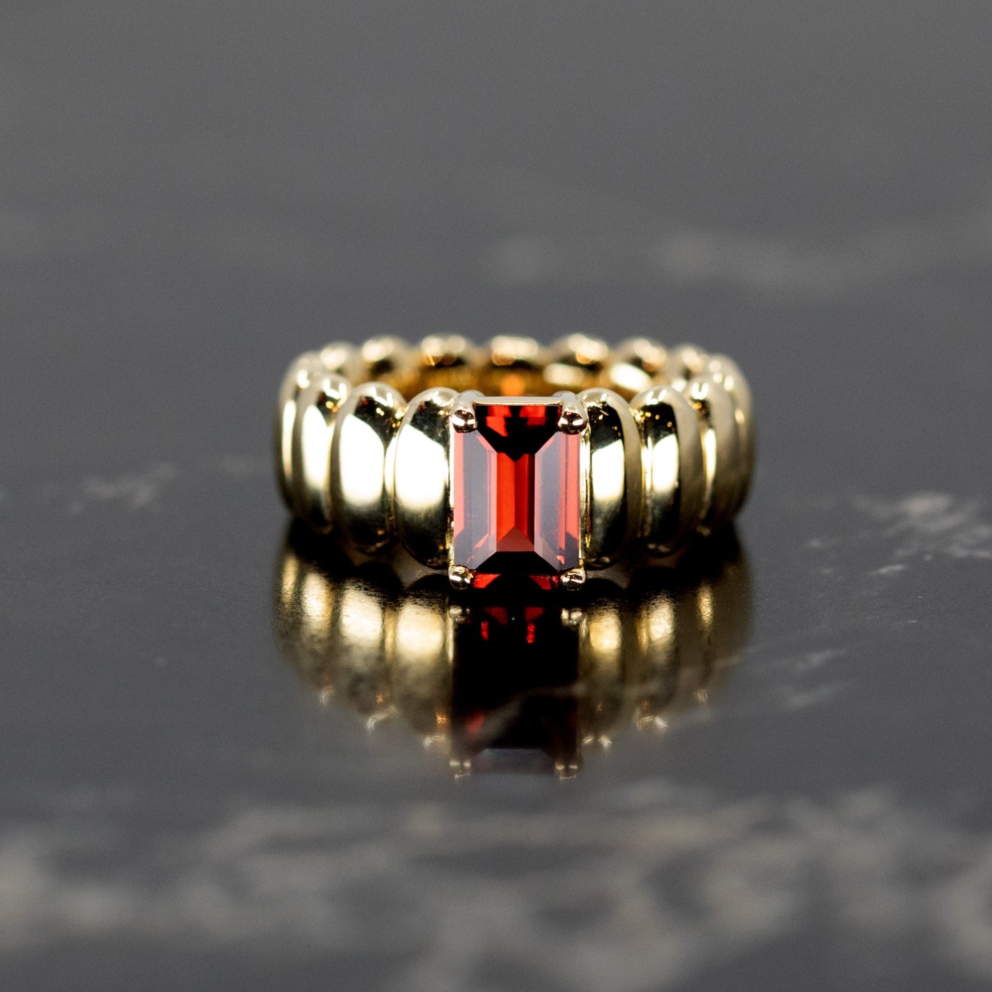 The Pyrope Pigalle Ring show in front view, demonstrating its bold presence and the elegance of the pyrope garnet set in yellow gold, crafted by Bena Jewelry in Canada.