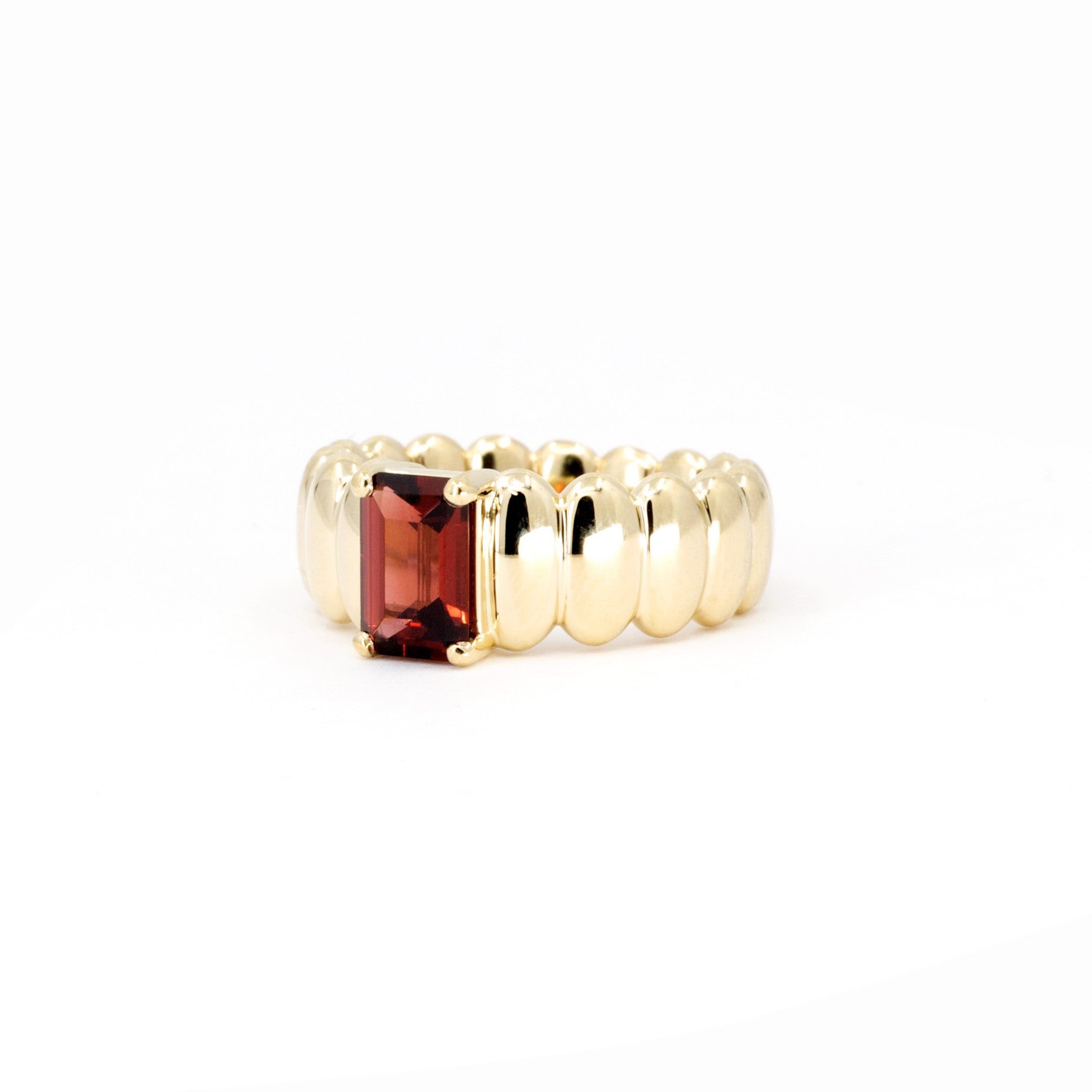 Side view of the Pyrope Pigalle Ring, revealing its smooth underside and meticulous craftsmanship, by Bena Jewelry designer, made with yellow gold in Montreal, Canada.