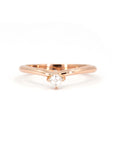 Curved rose gold ring with Asscher-cut diamond on white background, modern sculptural design, elegant and minimalist fine jewelry, by the desinger Bena Jewelry.