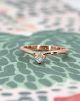 Front view of modern rose gold diamond ring, highlighting its sculptural curved band, designed by Bena Jewelry canadian designer.