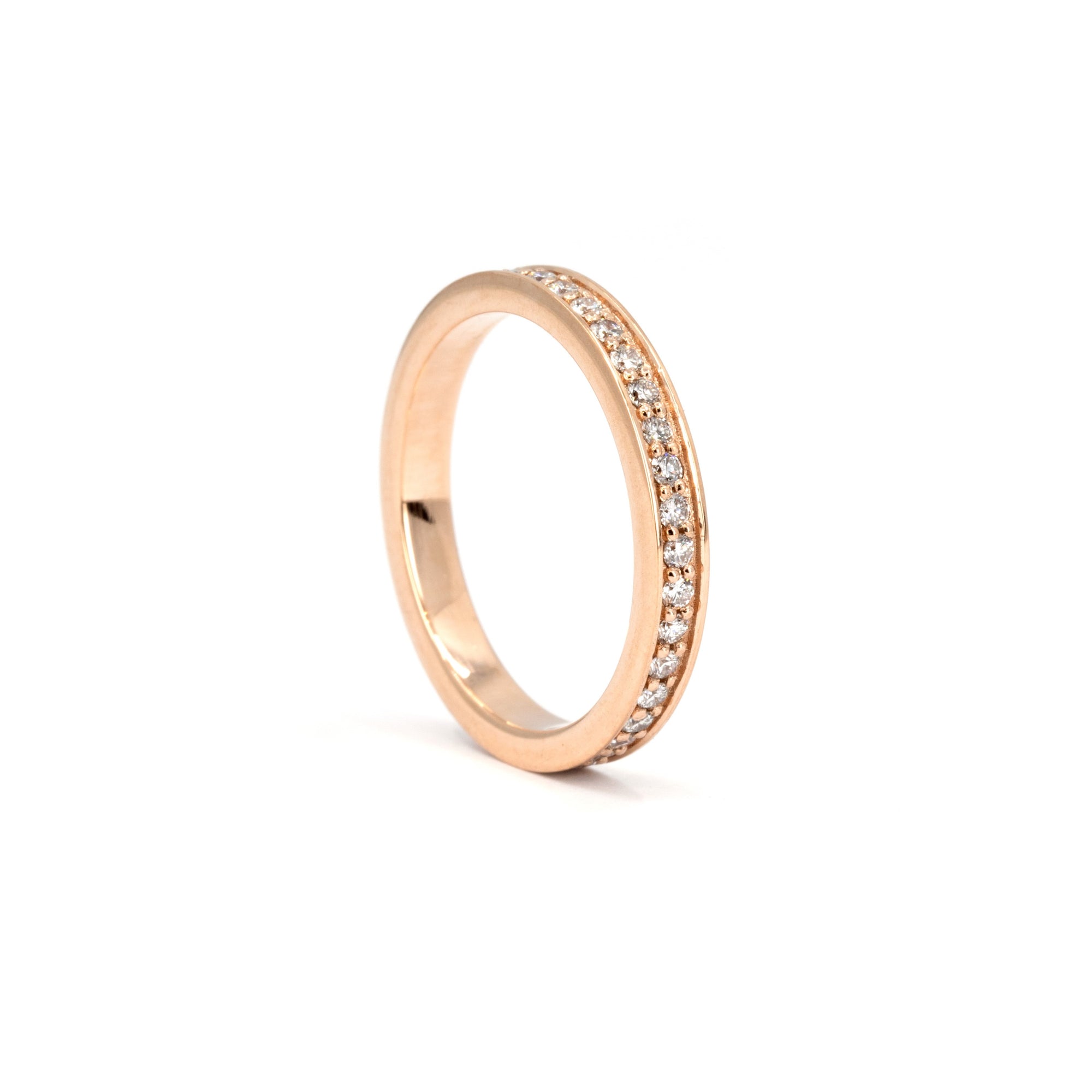 Close-up of the stunning 1.50 mm lab-grown diamonds in a pinpoint setting on a rose gold band. Handcrafted in Montreal, Quebec by Bena Jewelry, this wedding band offers brilliant shine and modern elegance.