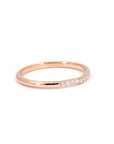 Close-up of the Luna Band, a minimalist rose gold ring with pavé diamonds, crafted by Bena Jewelry in Montreal. Perfect for stacking or as a wedding band.