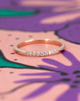 The Luna Band in rose gold, photographed on a contrasting background to highlight its warm glow and sparkling diamonds. Designed in Montreal by Bena Jewelry.