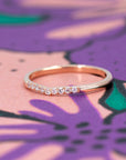 Elegant shot of the Luna Band by Bena Jewelry, featuring a graceful curve with pavé-set diamonds. A modern wedding or stacking ring in rose gold.