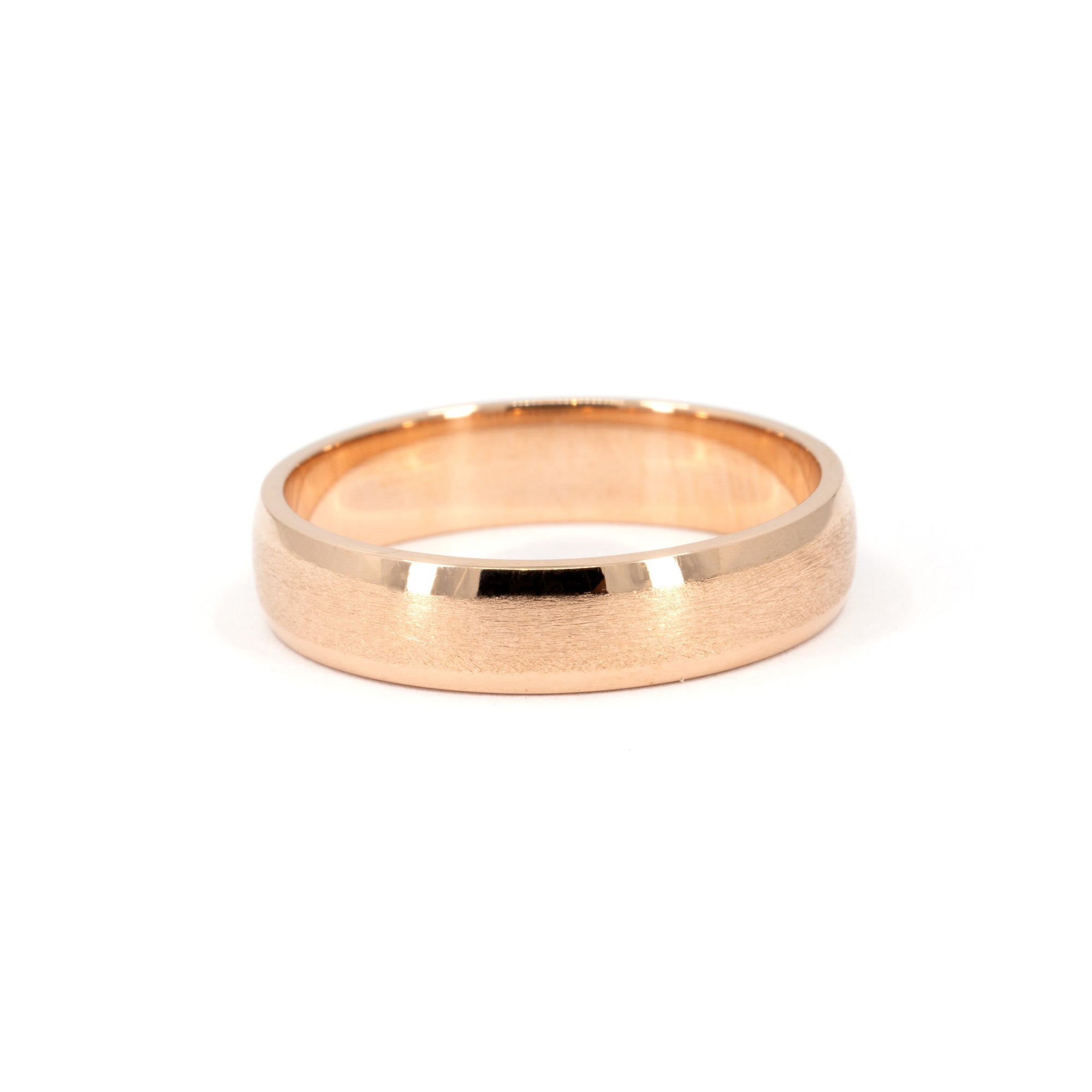 Rose gold men's wedding band with a matte center and polished edges, rounded profile. Handmade by Bena Jewelry in Montreal, Canada.
