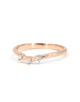 Delicate rose gold curved band with three brilliant lab-grown diamonds, elegantly set against a contrasting background. A modern yet timeless piece by Bena Jewelry, handcrafted in Montreal.