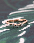 Elegant rose gold ring featuring a delicate arc design with three sparkling lab-grown diamonds. A refined piece by Bena Jewelry, made in Montreal.