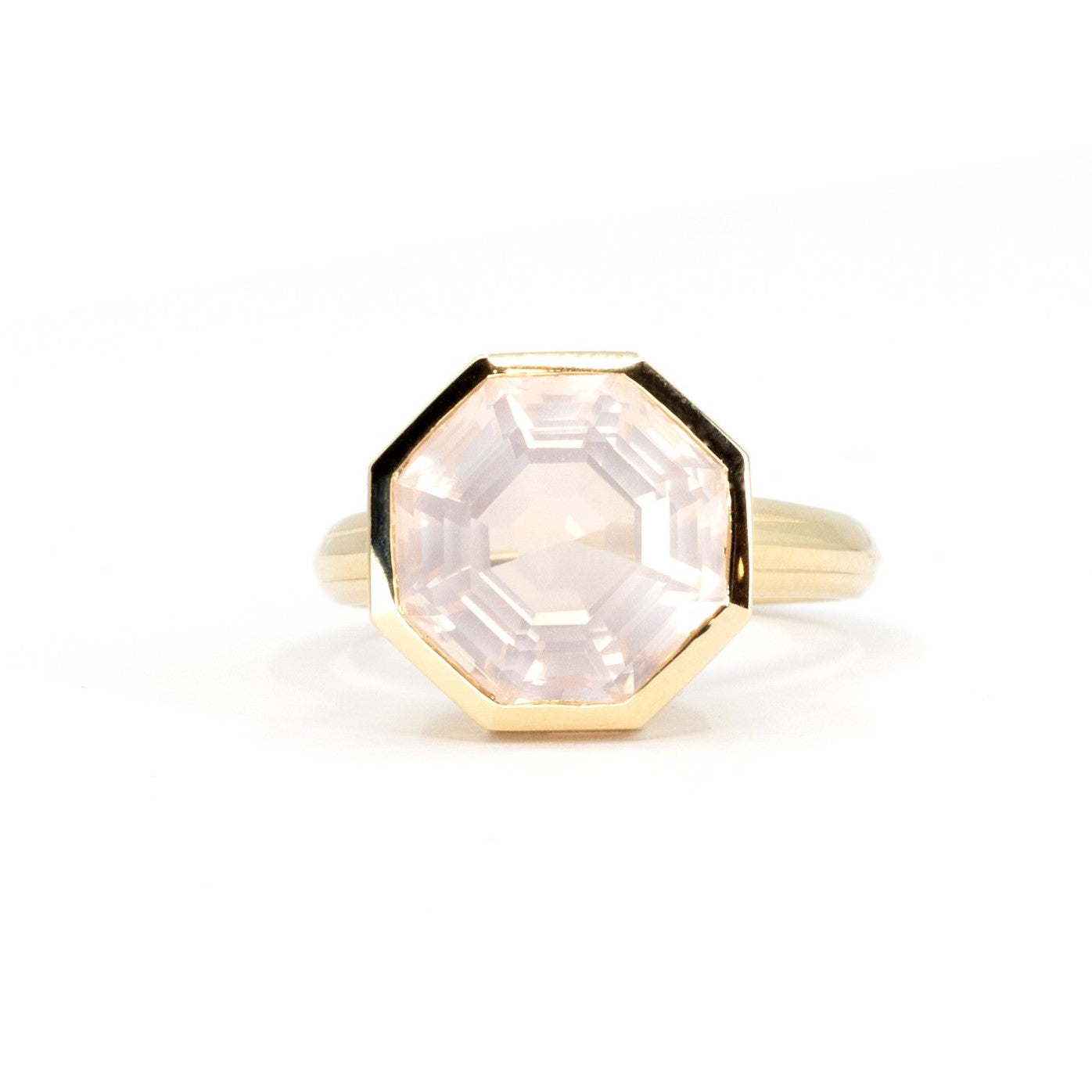 Front view of Bijou Rose Quartz Yellow Gold Ring with a cloudy pink rose quartz, bezel-set in yellow gold, displayed on a white background.