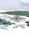 Lab-grown diamond halo engagement ring in white gold, photographed on a colored background. Showcasing timeless bridal elegance by Bena Jewelry, made in Montreal.