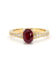 Front view on a white background: Imperial Ruby Ring in yellow gold with an oval ruby and pavé diamonds, a custom-made piece by Bena Jewelry in Montreal.
