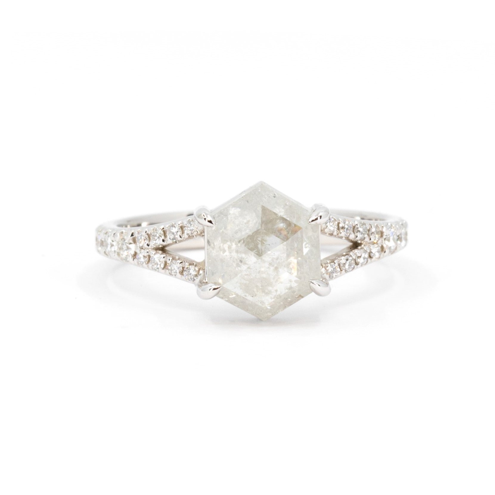 Hexagonal salt and pepper diamond ring with a split shank band, displayed on a white background. Custom bridal jewelry by Bena Jewelry, Montreal."