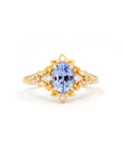 Sky Bloom Oval Sapphire Ring on white background – A floral-inspired engagement ring featuring a brilliant sky-blue oval sapphire in yellow gold. Handmade by Bena Jewelry in Montreal.