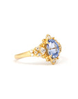 Close-up of Sky Bloom Ring – A natural oval sapphire with soft blue hues, set in a delicate yet intricate organic gold setting.