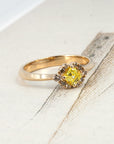 Artistic composition of a one-of-a-kind yellow and brown diamond ring by Canadian designer Bena Jewelry, photographed on a soft-toned backdrop for a modern look.