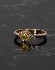 Bena Jewelry's Asscher-cut yellow diamond ring glowing against a dark background, emphasizing the golden tones and intricate brown diamond halo, handmade in Canada.
