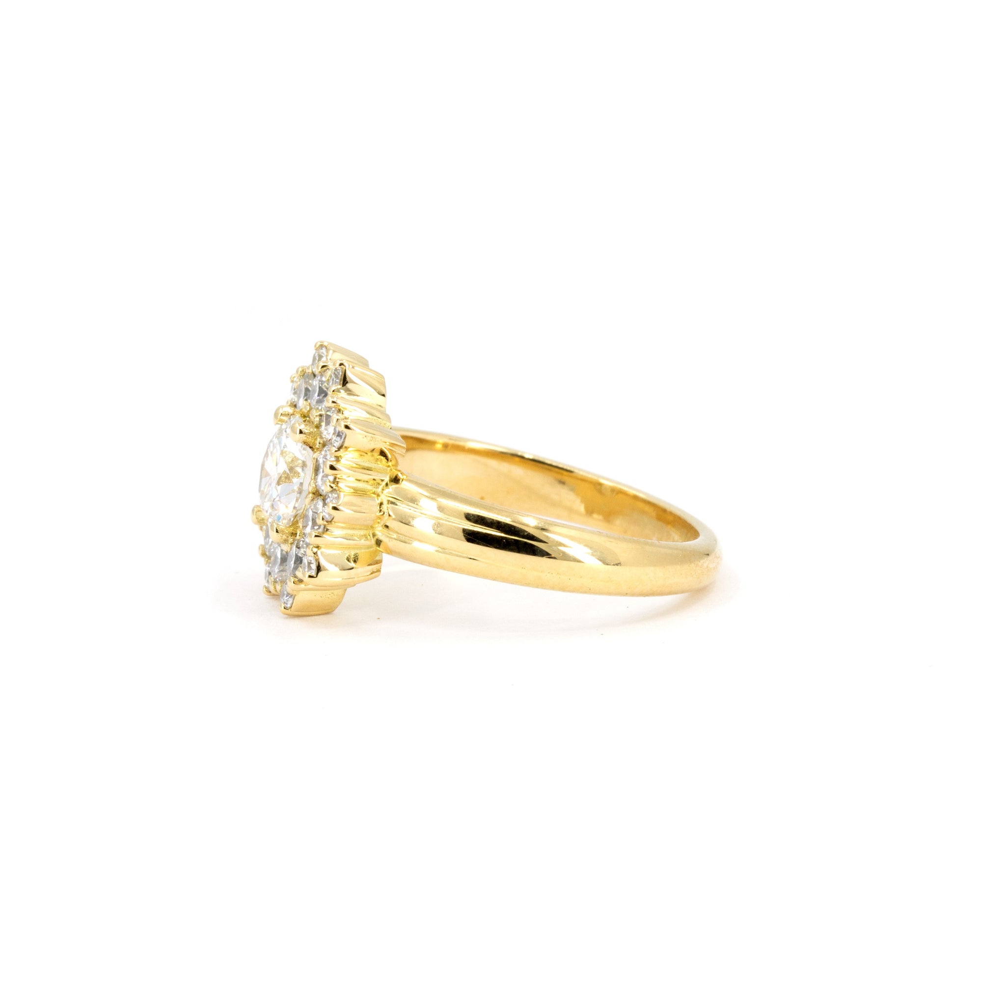 Side view of yellow gold engagement ring with floral diamond halo, crafted by Bena Jewelry in Montreal – white backdrop