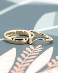 Close-up of the Custom V-Shaped Wedding Band and a men wedding band, made in Canada – A fine jewelry design with a subtle curve, crafted for a seamless bridal stack.