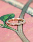 Close-up of the yellow gold bridal ring, featuring alternating marquise and round diamonds.