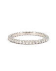 White gold eternity band with 1.50 mm round diamonds by Bena Jewelry. This sleek, custom-made ring is handcrafted in Montreal, showcasing its elegant design and timeless brilliance.