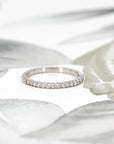 Close-up view of the 1.50 mm round diamonds on the white gold eternity band by Bena Jewelry. A perfect blend of sparkle and precision, highlighting its expert craftsmanship.