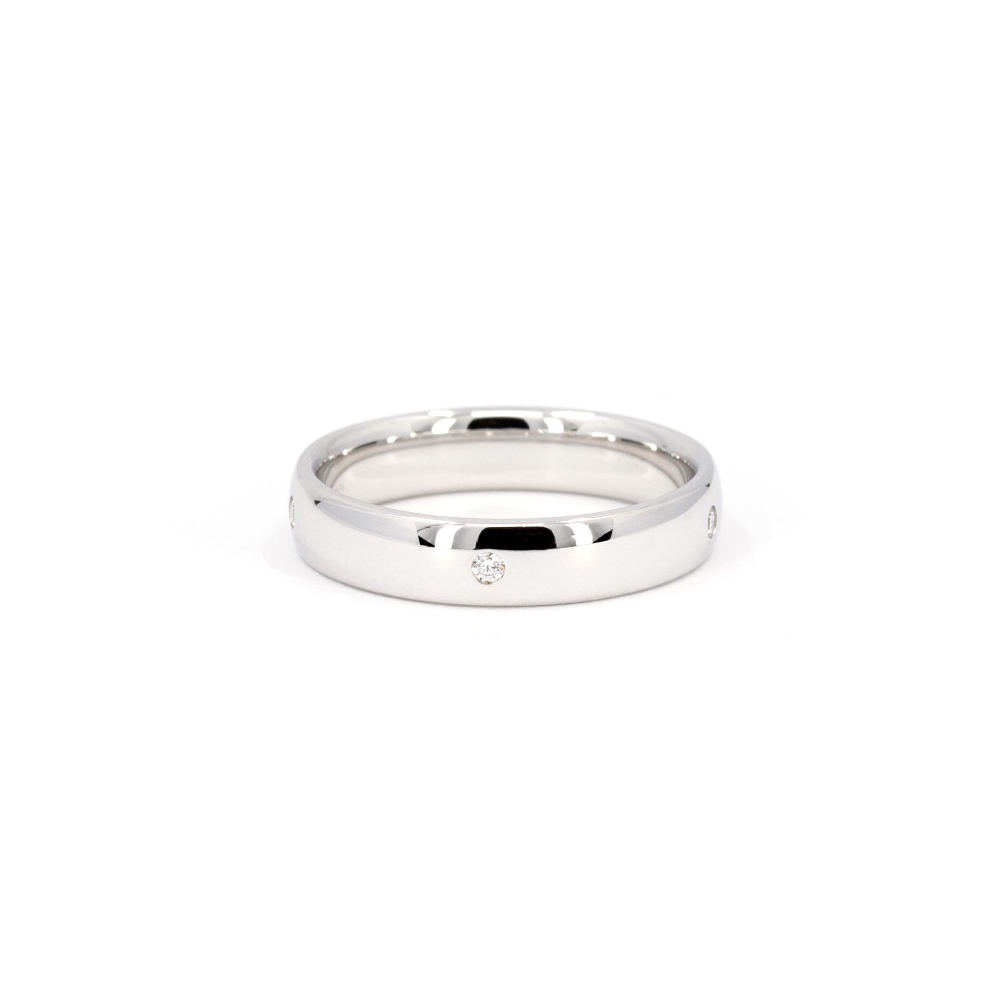 Elegant domed white gold wedding ring featuring diamonds by Bena Jewelry displayed on a plain white background fine bridal jewelry from Canada