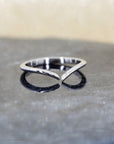 A refined white gold wedding band featuring natural diamonds, showcased on a textured natural black quartz surface with a sparkling gold backdrop that enhances its elegance and brilliance. Designed and handcrafted in Montreal by Bena Jewelry.