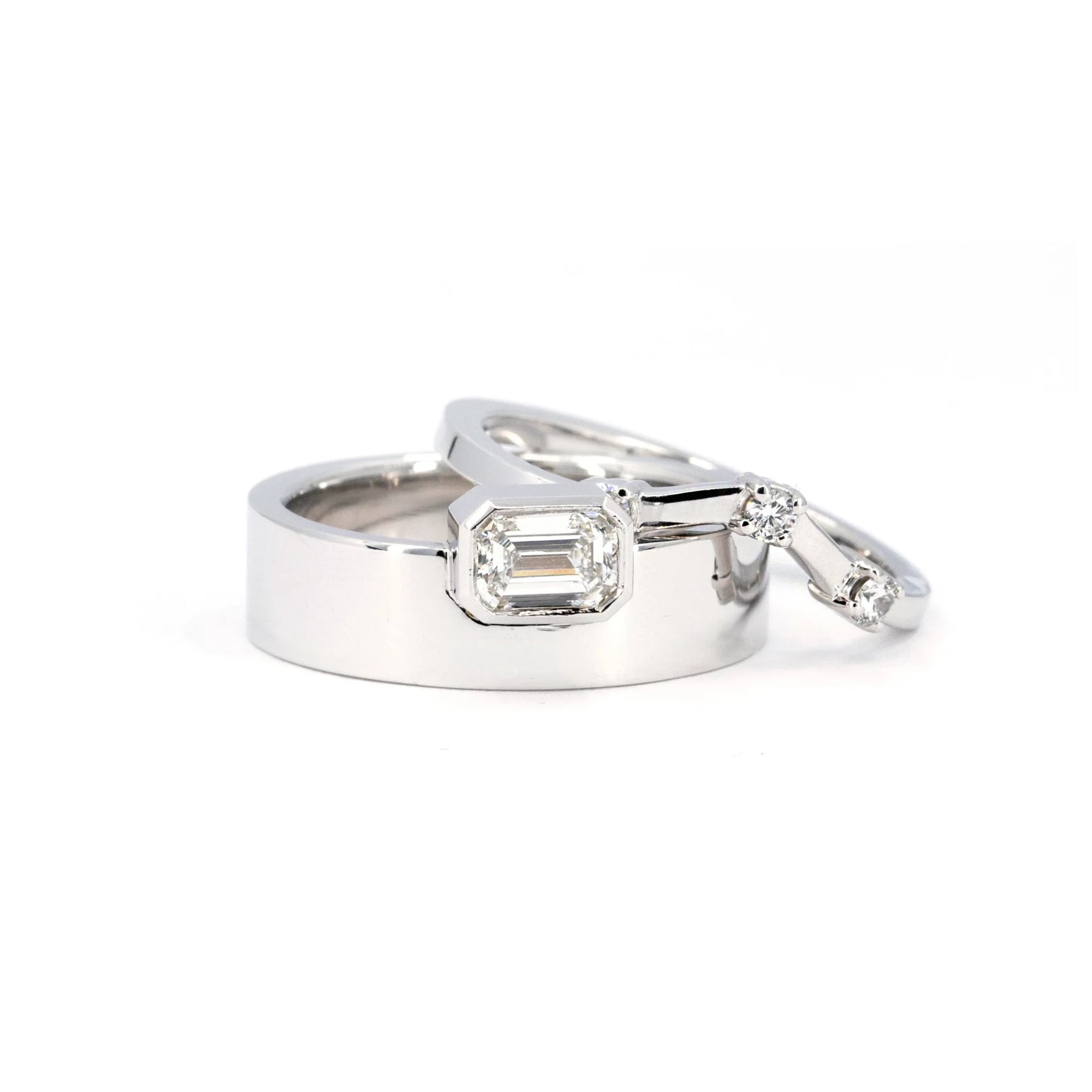 Contemporary white gold ring with an emerald-cut diamond, paired with a matching band in a bold, boxy design. An exceptional piece by Bena Jewelry, showcasing modern elegance and craftsmanship. Handcrafted in Canada, this statement set is available at Bena's jewelry collection.
