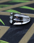 Close-up of Crush Ring in White Gold – A statement designer ring with sculptural, stacked edges for a strong, modern aesthetic.