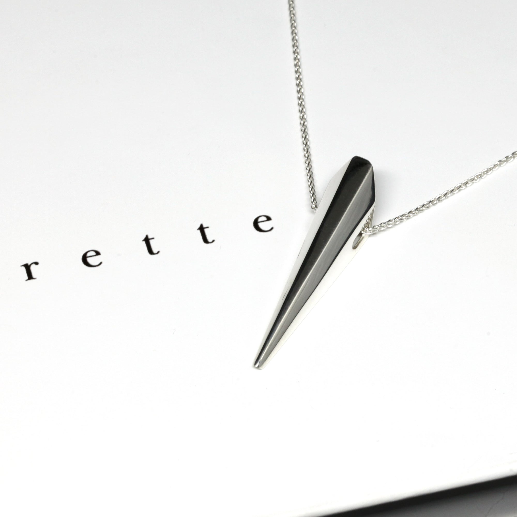 Close-up of the White Gold Pike Pendant, handcrafted in Montreal – A striking fine jewelry piece with sharp, sculptural lines and a polished surface.