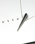 Close-up of the White Gold Pike Pendant, handcrafted in Montreal – A striking fine jewelry piece with sharp, sculptural lines and a polished surface.