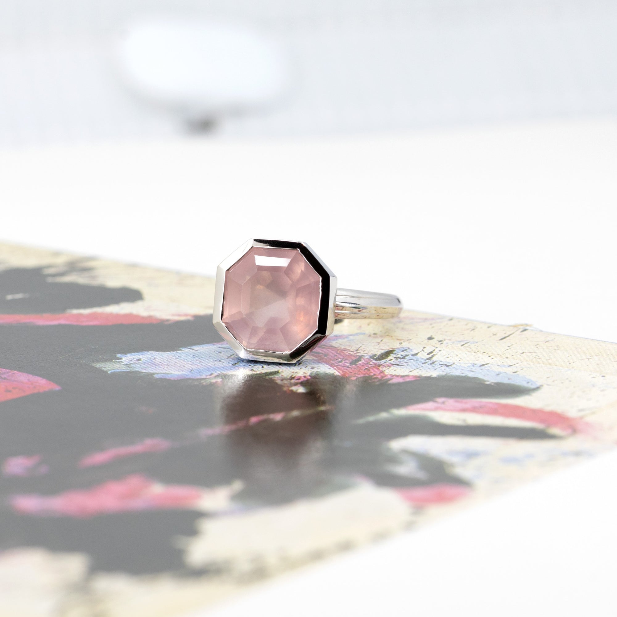 Front view of Bijou Bubble Pink Rose Quartz Ring, featuring a unique bold design, photographed on a colorful surface.