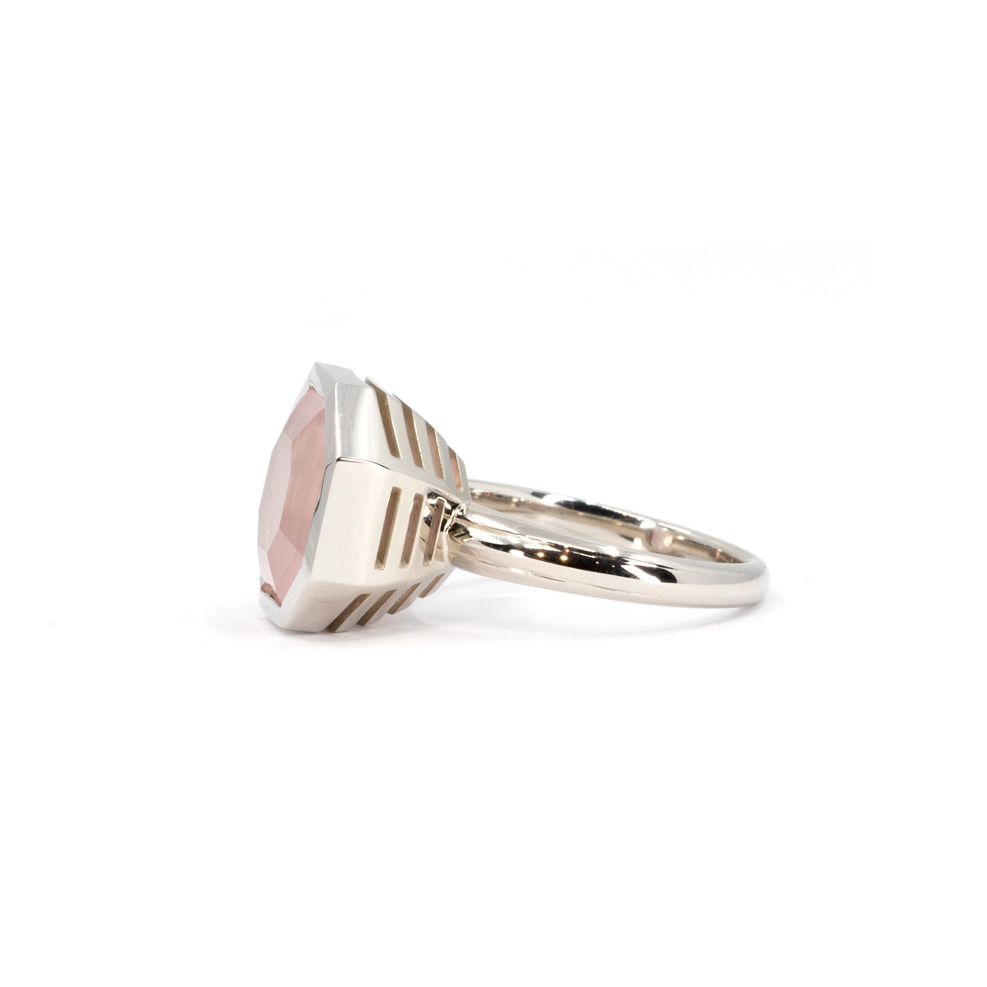 Side view of the pink quartz cocktail ring in white gold, part of the Fancy Edgy collection by Bena Jewelry, photographed on a clean white surface.