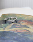 Fine white gold wedding band with natural diamonds, displayed on a colored background. Custom-made bridal jewelry by Bena Jewelry, Montreal.