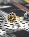 Side view product image of a sunburst ring set against a dark backdrop. This ring features a broad yellow gold band, highlighted by a round yellow laboratory diamond at its center, encircled by round gold/brown diamonds and sparkling white diamonds. Designed by independent fine jewelry designer Bena Jewelry.