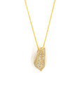 Close-up of the Ballast pendant, highlighting the dazzling diamond pavé set in yellow gold. Crafted with precision, this pendant combines bold design with sparkling brilliance.